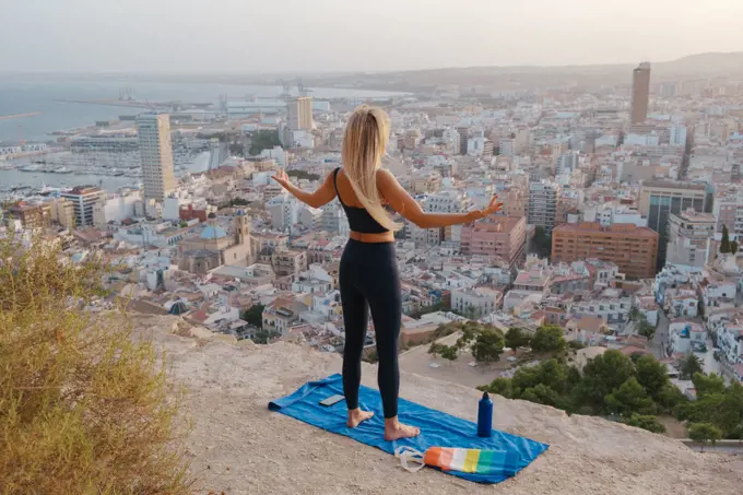 girl does sports and yoga outdoors on gay pride day