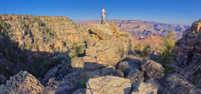 Hiker climbing boulders at Grand Canyon AZ