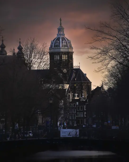 amsterdam canal at sunrise with bridge and boats