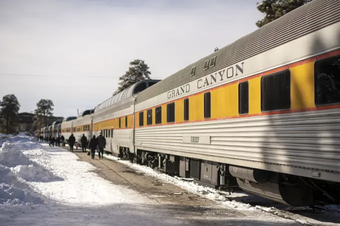 Passengers walk along side of the Grand Canyon Railway train in winter