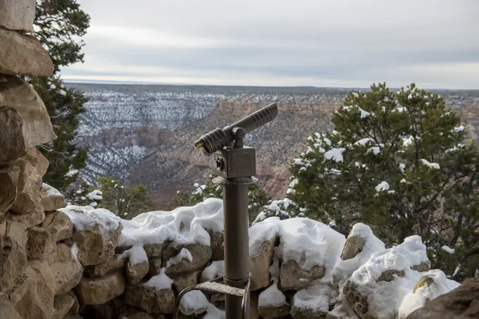 Snow covered coin-operated viewer at a South Rim Grand Canyon overlook