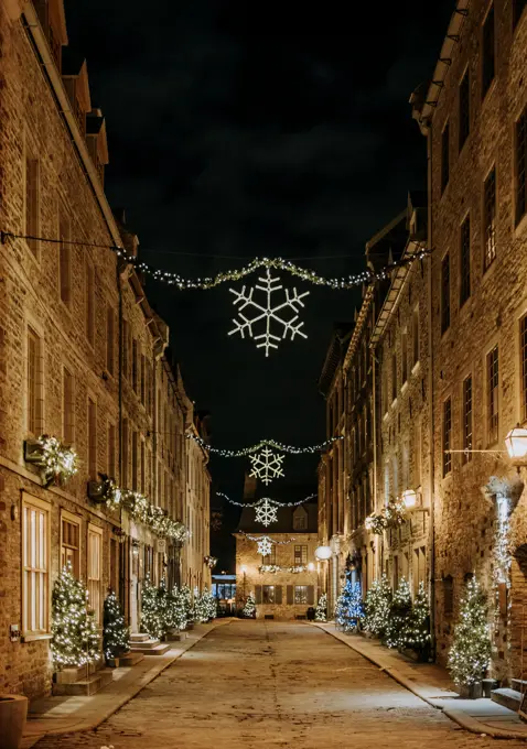 Old street Quebec City lit up at night decorated for Christmas holiday