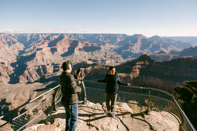 Dad taking photo of daughter at The Grand Canyon