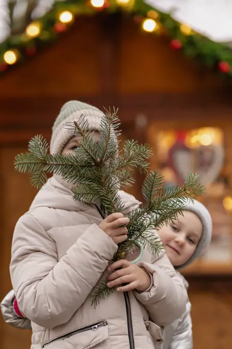 Two girls walk at the Christmas market in Germany, gingerbread