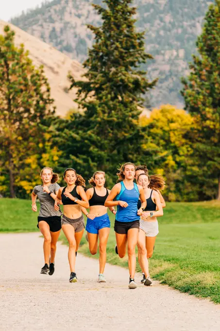 College female student athletes running during track practice