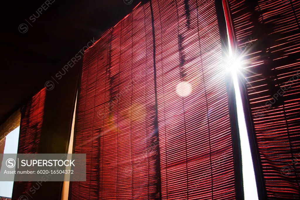 sunlight shinning through window with red curtains
