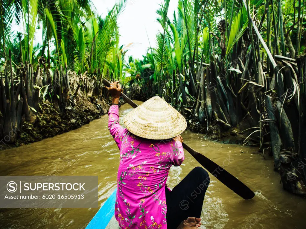 Traditional Vietnamese boat rowing down the Mekong Delta, Vietnam, Southeast Asia