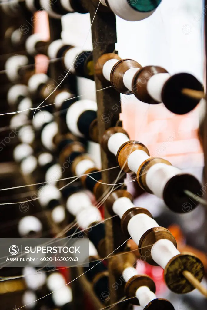 Detail of spools of thread on a weaving loom, Vietnam, Southeast Asia