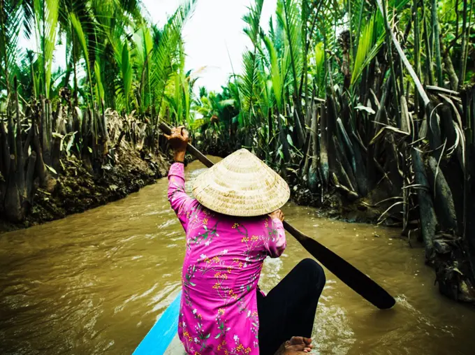 Traditional Vietnamese boat rowing down the Mekong Delta, Vietnam, Southeast Asia