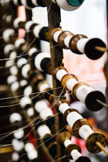 Detail of spools of thread on a weaving loom, Vietnam, Southeast Asia