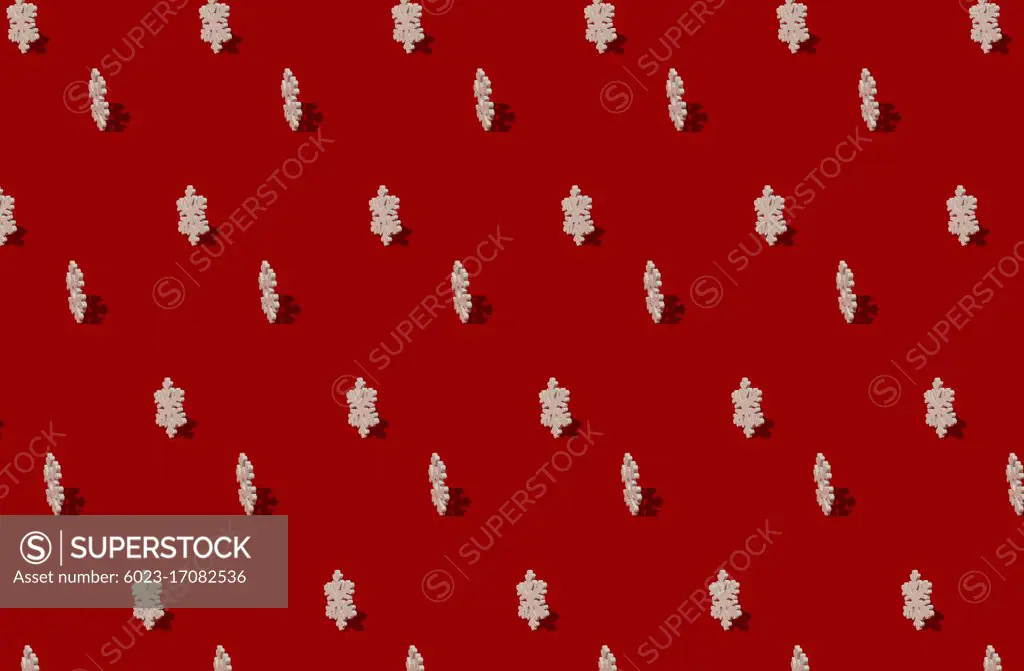 wooden snowflakes pattern on red background