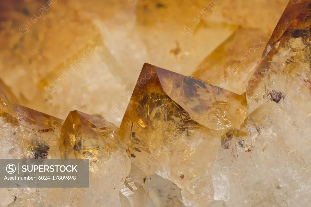 Macrophotograph of citrine cyrstals; citrine is a variety of quartz and the coloration comes from tiny particles of iron oxide suspended within