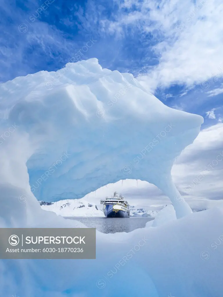 National Geographic Resolution though window in sculpted iceberg in Wilhelmina Bay, Antarctica