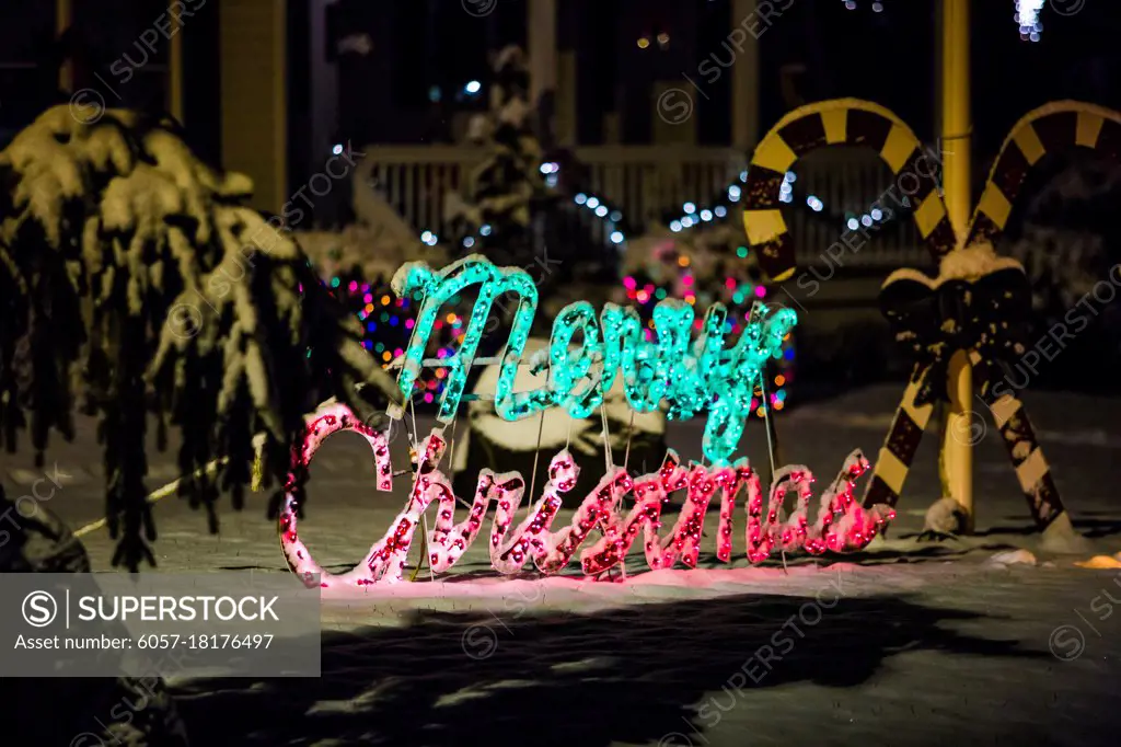 Decorated house for Christmas at night covered in snow