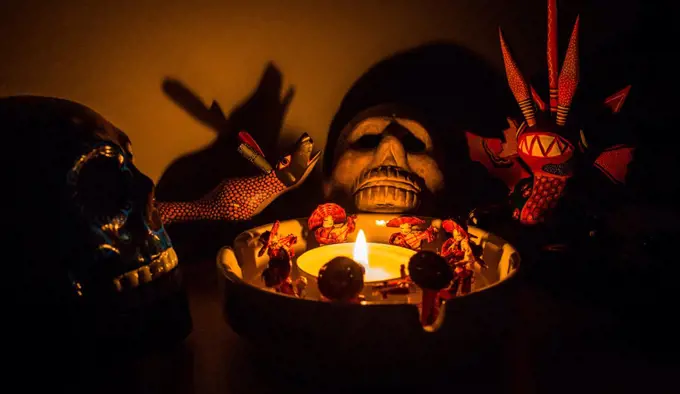 scary shaman ritual figures around a candle at night mariachi