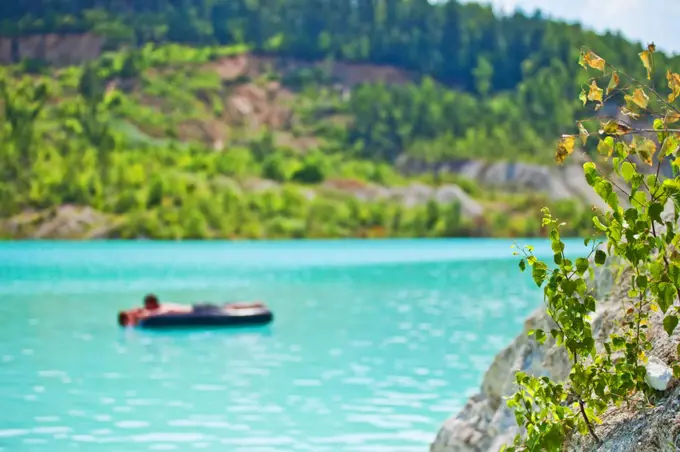 Swimming on a mattress in a beautiful place blurred