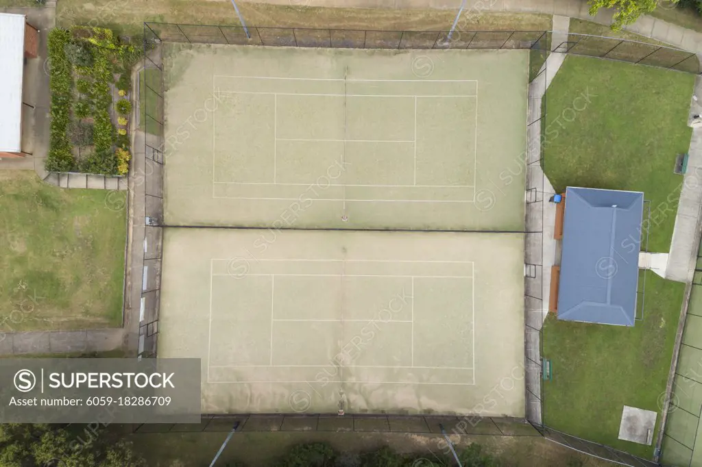 An overhead view of a tennis court in the suburbs