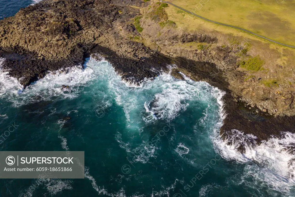 Drone aerial photograph of the ocean crashing against rocks in Kiama on the south coast of New South Wales in Australia