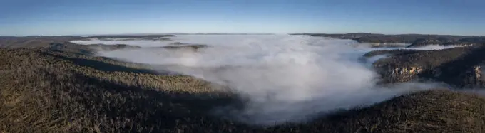 Drone aerial photograph of fog in a large valley in The Blue Mountains in New South Wales in regional Australia