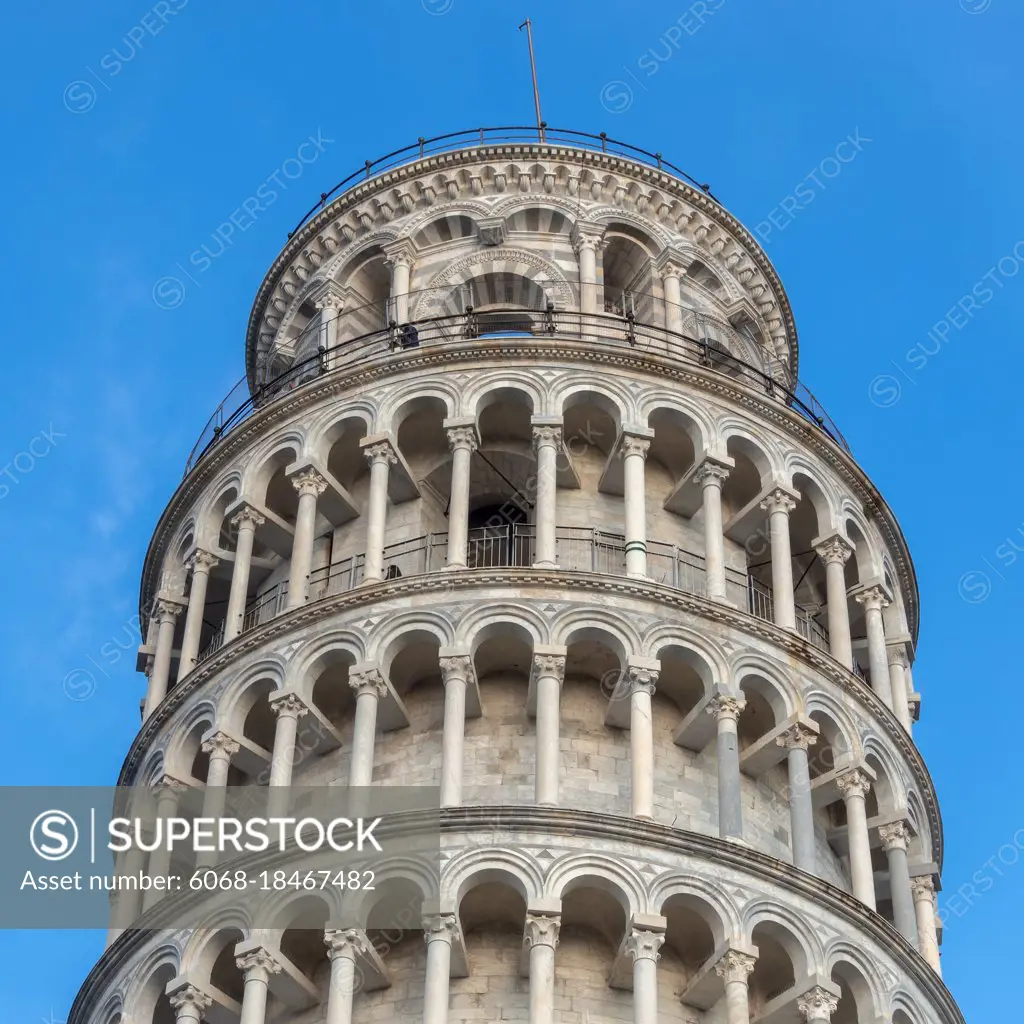 PISA, TUSCANY/ITALY  - APRIL 17 : Exterior view of the Leaning Tower of Pisa Tuscany Italy on April 17, 2019. Three unidentified people