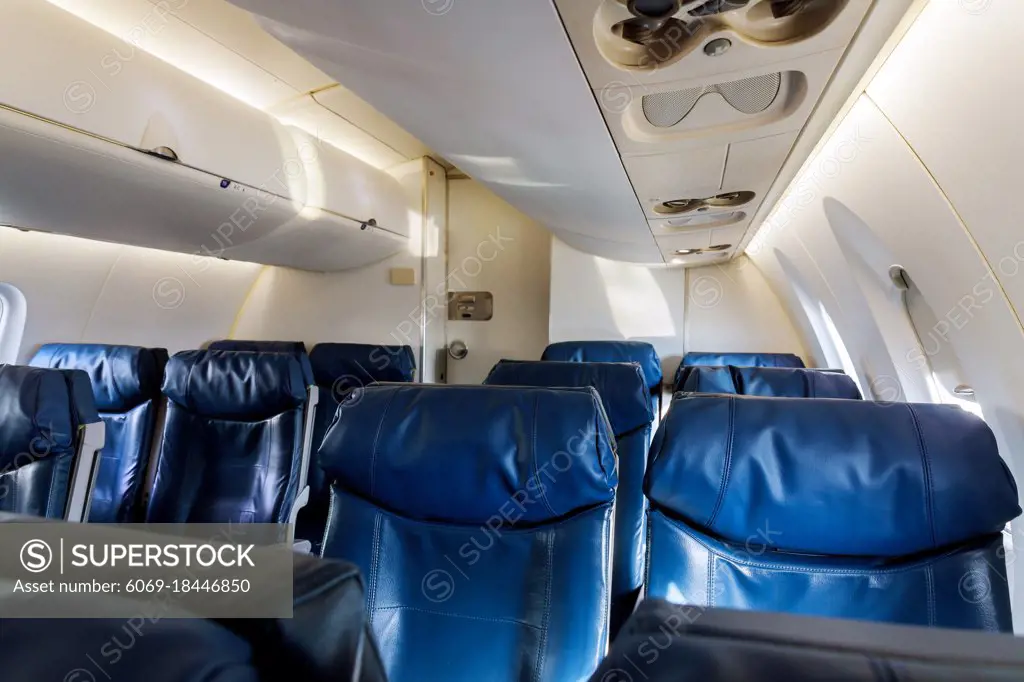 Airplane inside interior passenger airliner of the aircraft during the flight of tourists flying