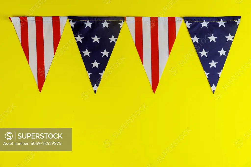 Pennants of stars and stripes flags yellow background american holiday US independence day