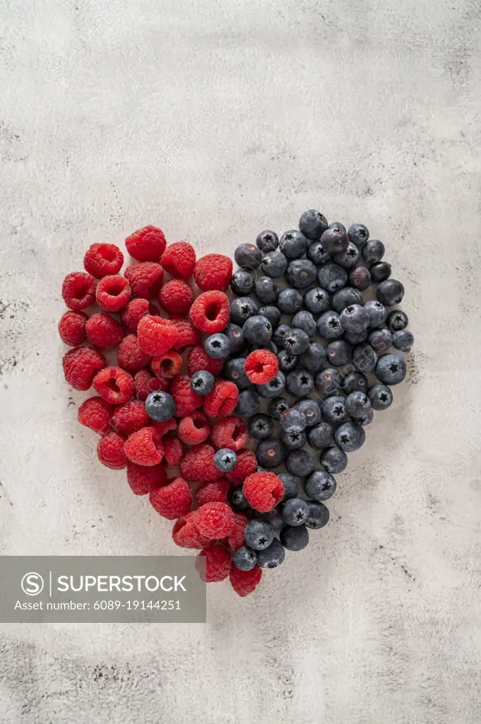 Raspberry and blueberry heart. Healthy food, nutrition and detox concept. Top view