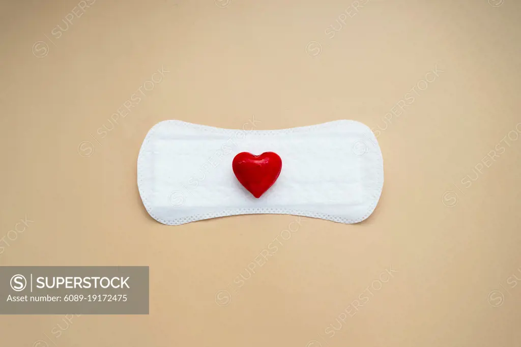 Woman's sanitary pad with red heart. Abstract Woman's health concept. Menstruation or period pad