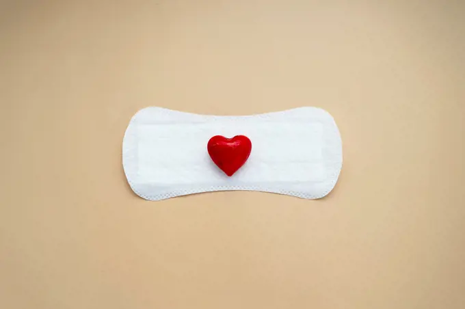 Woman's sanitary pad with red heart. Abstract Woman's health concept. Menstruation or period pad