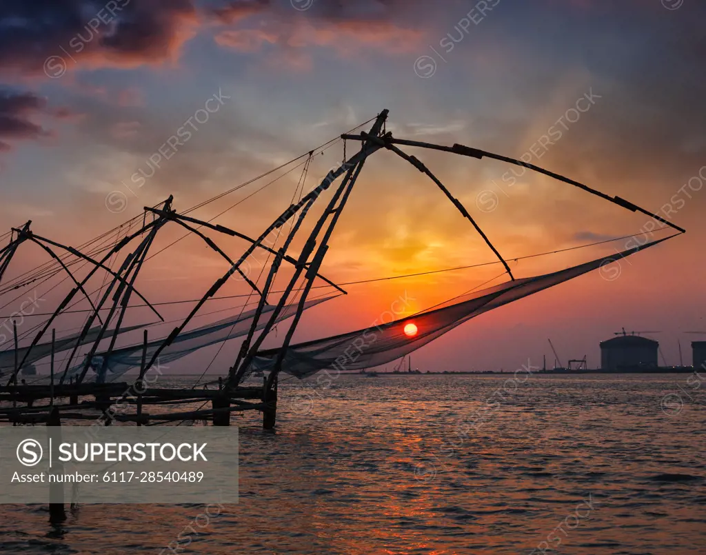 Kochi tourist attraction - chinese fishnets on sunset. Fort Kochin, Kochi,  Kerala, India - SuperStock