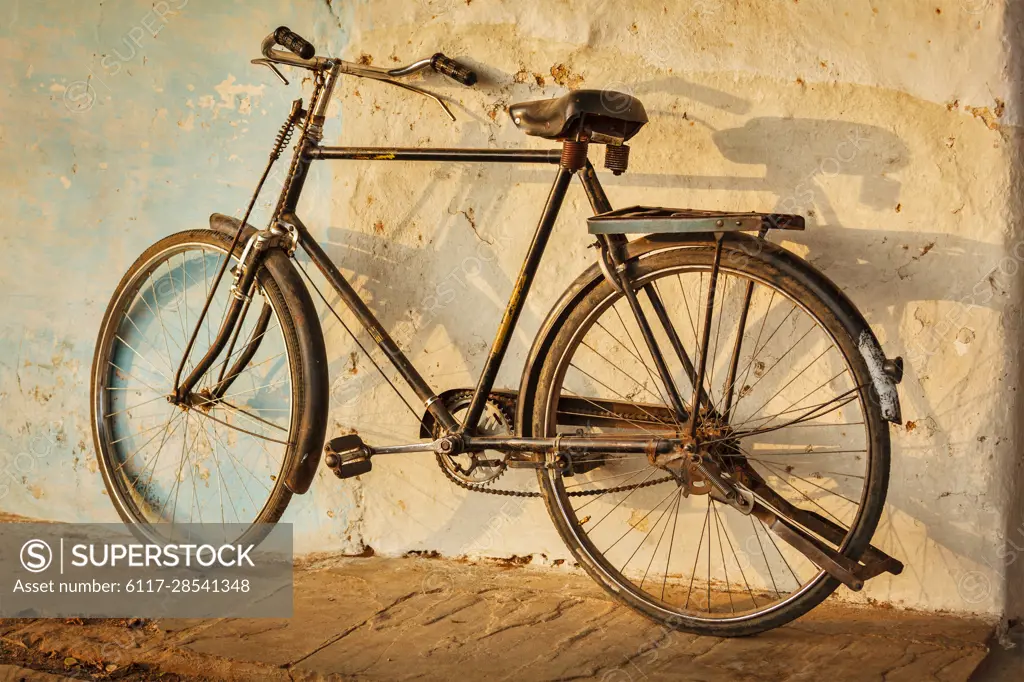 Old Indian bicycle in the street of India - SuperStock