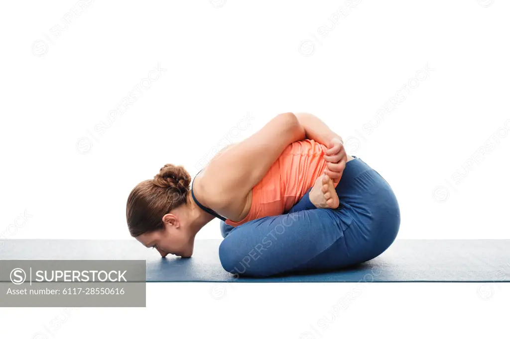 Woman doing Asthanga Vinyasa Yoga asana Yoga mudrasana (yoga mudra) -  psychic union pose isolated on white background - SuperStock
