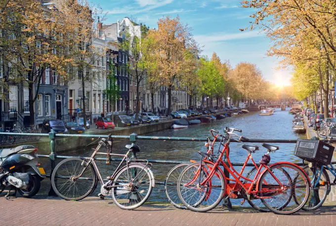 Amsterdam cityscape with canal, bridge with bicycles and medieval houses. Amsterdam, Netherlands