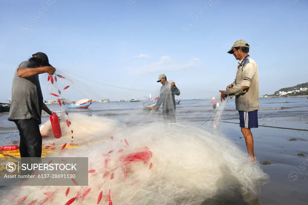 Fishermen repairing fishing nets. Hang Dua bay. Vung Tau. Vietnam. -  SuperStock