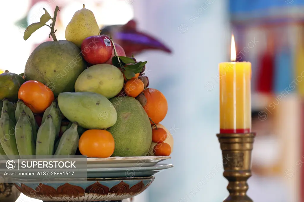 Cao dai temple. Offerings and candle on altar.  Tan Chau. Vietnam.