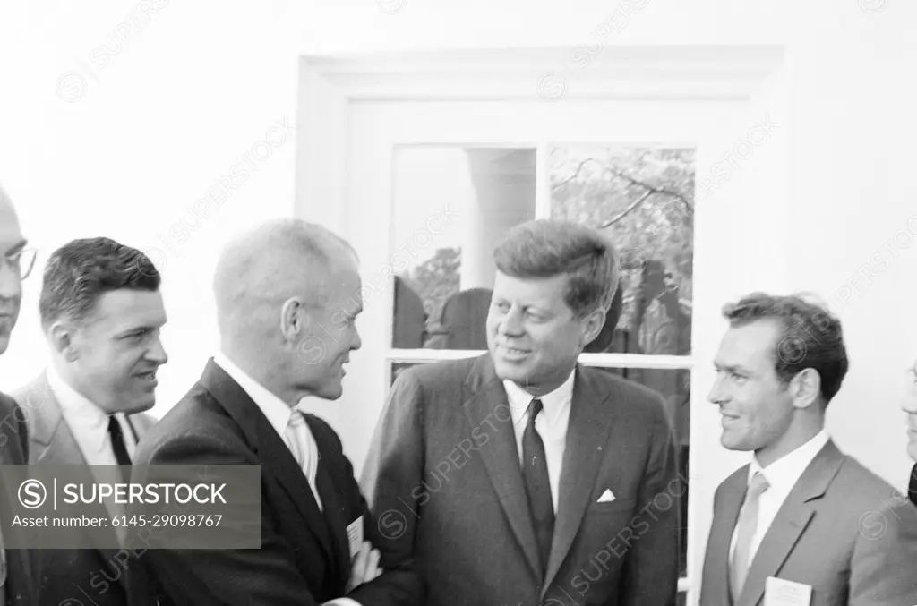 Visit of Gherman S. Titov, Russian Cosmonaut (astronaut), and John Glenn, American Astronaut, 12:47PM. President John F. Kennedy visits with Russian cosmonaut Major Gherman S. Titov and American astronaut Colonel John H. Glenn, Jr. Left to right: Interpreter Walter Skuby, Colonel Glenn, President Kennedy, Major Titov. West Wing Colonnade, White House, Washington, D.C.