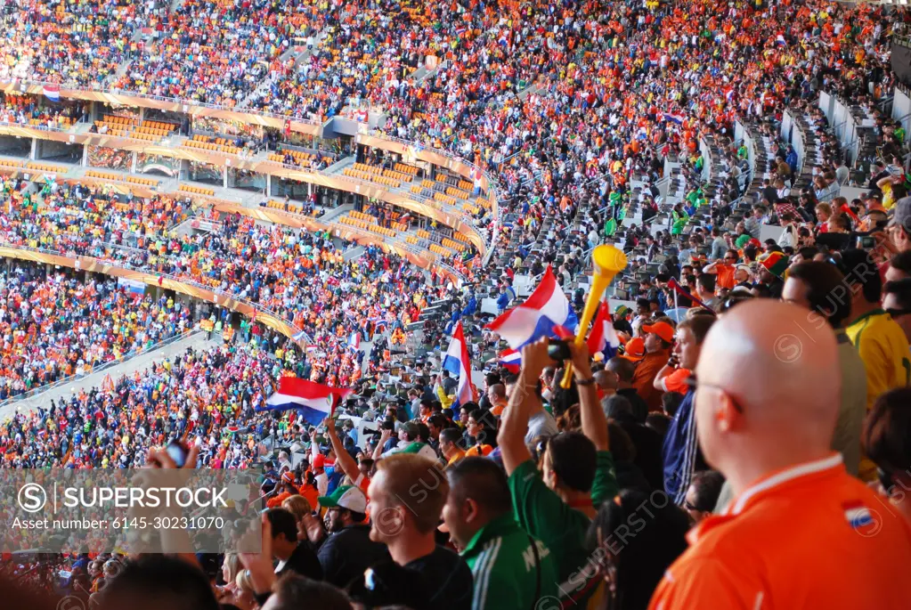 Dutch and Danish fans cheer during the Netherlands vs. Denmark World Cup soccer match at Soccer City Stadium in Johannesburg, South Africa, on June 14, 2010.