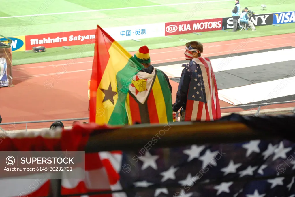 Ghanaian and American fans cheer for their respective teams during the FIFA 2010 World Cup soccer match between the United States and Ghana on June 26, 2010, at the Royal Bafokeng stadium in Rustenburg, South Africa.