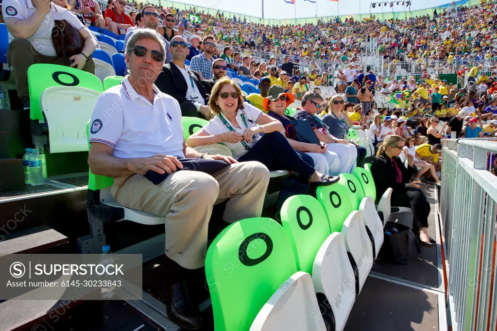 U.S. Secretary of State John Kerry and U.S. Ambassador to Brazil Liliana Ayalde watch an Olympic men's beach volleyball game on the Copacobana beach in Rio de Janiero, Brazil, while they and their fellow members of the U.S. Presidential Delegation visit the Summer Olympics on August 6, 2016.