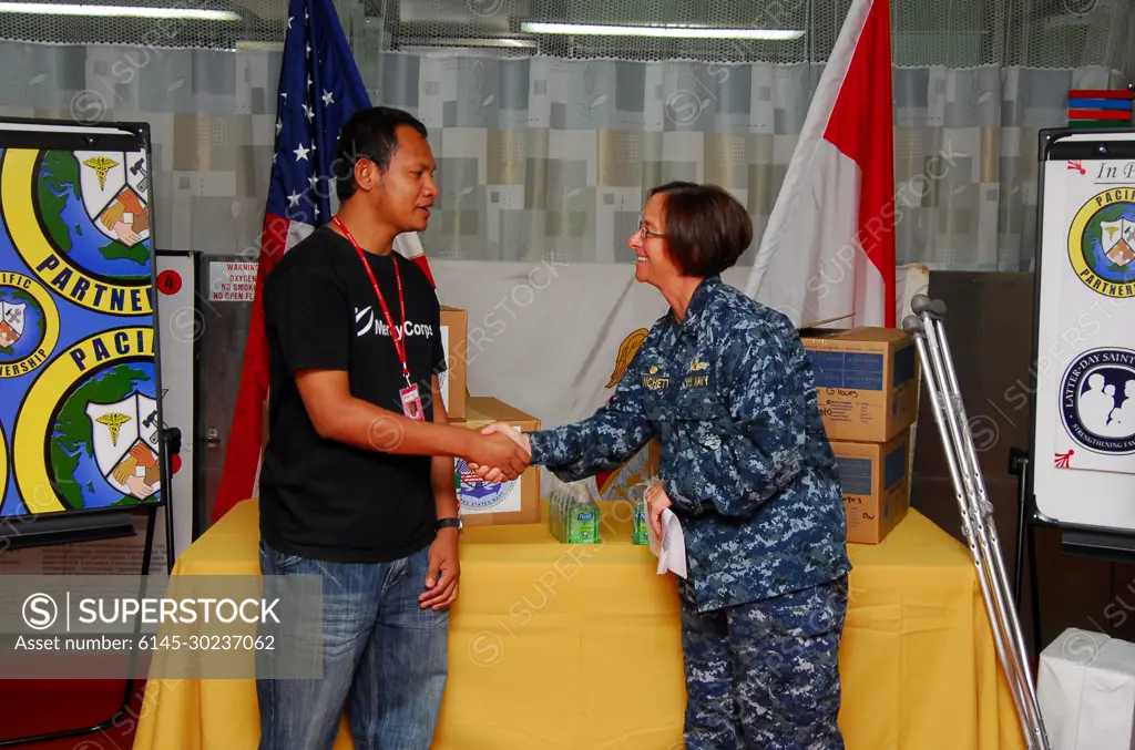 Pacific Partnership 2010 Commander Capt. Lisa M. Franchetti greets Mercy Corp head of Maluku field offices Florindo Michael Bell during a ceremony while aboard the Military Sealift Command hospital ship USNS Mercy (T-AH 19) on July 30, 2010. Mercy is in Ambon, Indonesia, participating in Sail Banda 2010, a series of events hosted by the Government of Indonesia to promote the future of small islands. Mercy�s participation features medical and dental care clinics and construction projects in and around Ambon, as well as on Seram Island.