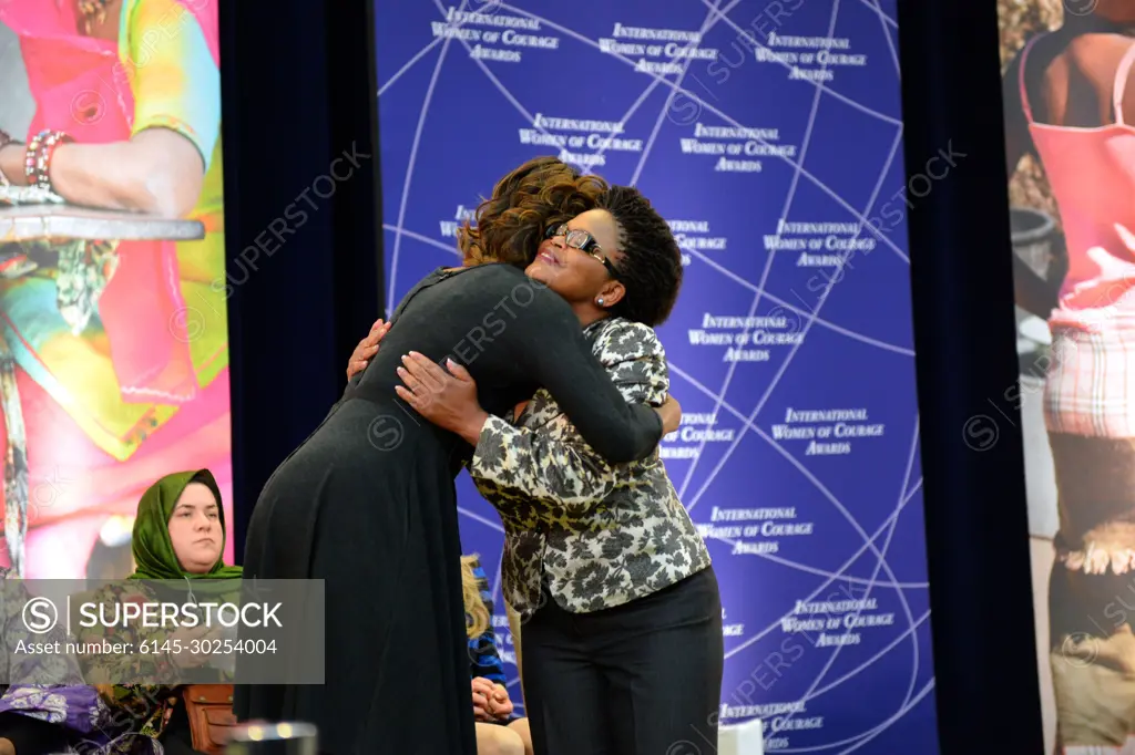 First Lady Michelle Obama embraces 2014 International Women of