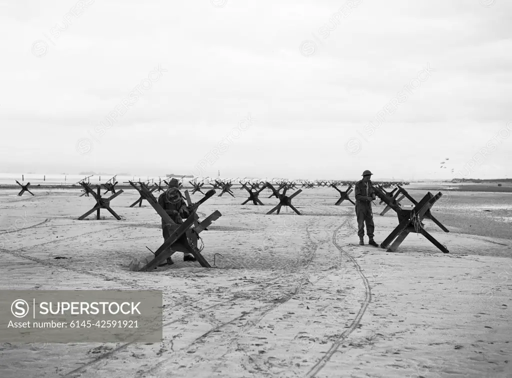 Operation Overlord (the Normandy Landings)- D-day 6 June 1944 The British 2nd Army: Royal Navy Commandos at La Riviere preparing to demolish two of the many beach obstacles designed to hinder the advance of an invading army.