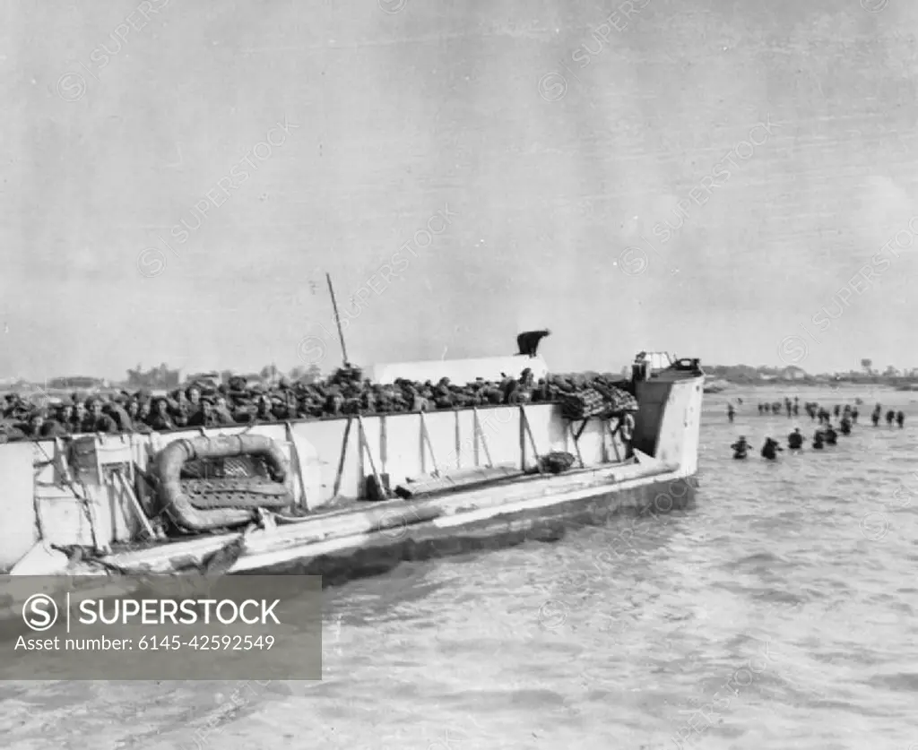 The Allied Invasion of Normandy, D-day, 6 June 1944 Troops disembark from a LCT (Landing craft (Tank)) and begin wading to the shore during the D-Day landings.