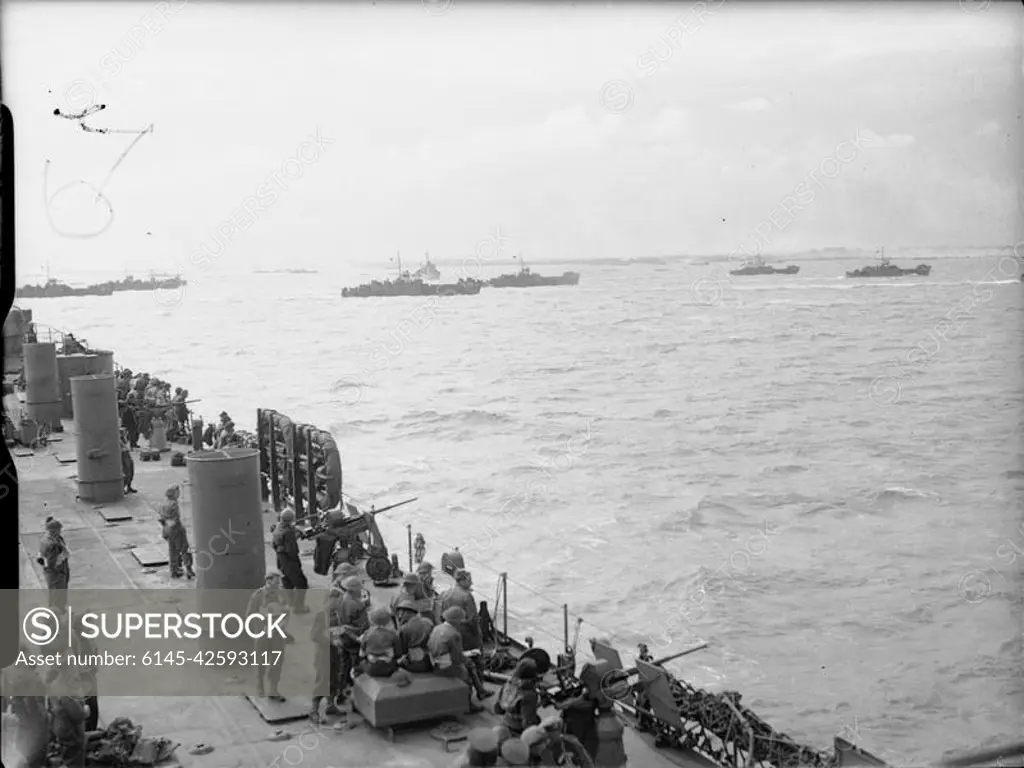 D-day - Allied Forces during the Invasion of Normandy 6 June 1944 British troops and US sailors manning 20mm gun positions on board USS LST-25 watch LCI(L) landing craft head towards the beaches of Gold assault area, 6 June 1944.