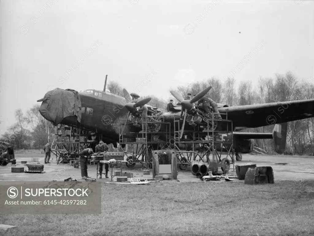 Royal Air Force Bomber Command, 1942-1945. Ground crews overhaul the Rolls-Royce Merlin XX engines of Handley Page Halifax Mark II, BB194 'ZA-E', of No. 10 Squadron RAF, in a dispersal at Melbourne, Yorkshire.