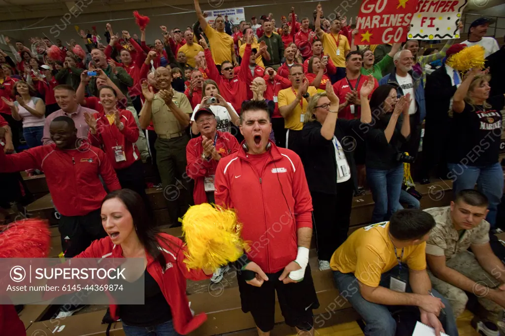 Fans and spectators of the all Marine sitting volleyball team erupt after the team scored the game wining point of the inaugural Warrior Games sitting volleyball competition May 13, 2010. The Marines won the gold medal defeating the Army 15 to 9 in the last game of a best-out-of-three championship.