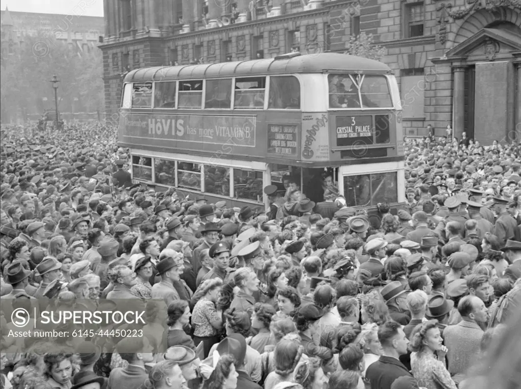 Ve Day Celebrations in London, England, UK, 8 May 1945 A number 3 double-decker bus slowly pushes its way through the huge crowds gathered in Whitehall to hear Churchill's Victory speech and celebrate Victory in Europe Day. The crowd is a mix of service personnel, civilians and children. Behind the bus, people line the balconies of the buildings along the street, and in the background, Westminster Abbey can be seen. :         8  1945