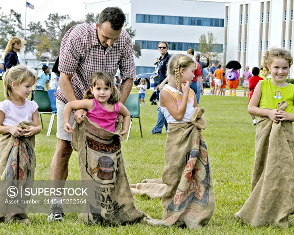 From left, Mallory Doody, 5, Natalie Cambre, 3, Madison Doody, 7, and Anna Cambre, 6, get ready to compete in a sack race. The children were participants in Nickelodeon's Worldwide Day of Play celebration at Stennis Space Center (SSC) on Oct. 1. The Worldwide Day of Play is sponsored annually by Nickelodeon television network to encourage children to be physically active.