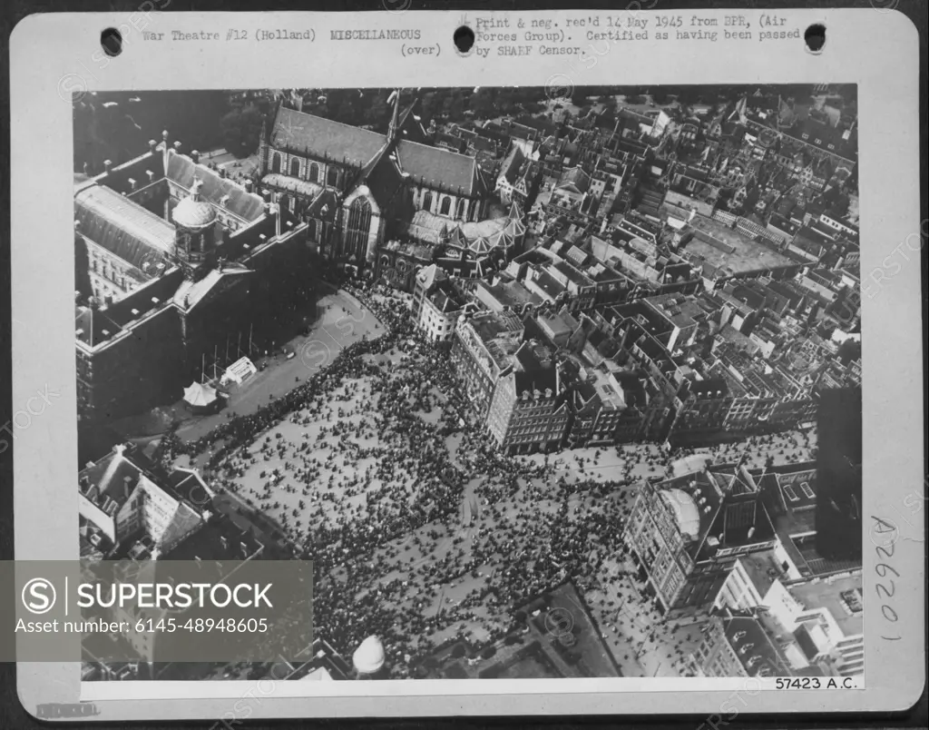 LITERATED AMSTERDAM CELEBRATES VE DAY-The people of Amsterdam, Holland throng the cathedral square to celebrate VE Day. It marks the end of five years of German oppression and they are overjoyed that the war has come to an end.