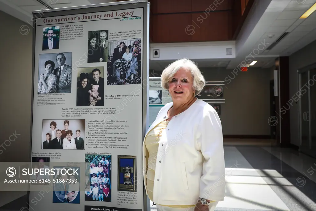 South Carolina Council on the Holocaust Chair, Dr. Lilly Filler, poses in front of a banner of her family history during U.S. Army Central's Days of Remembrance event at Patton Hall on Shaw Air Force Base, S.C., April 29, 2022. Dr. Filler's mother and father were both survivors of the Holocaust.